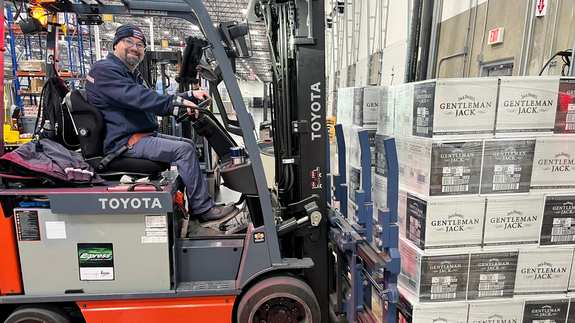 Man on a forklift with cases of Gentleman Jack in a warehouse