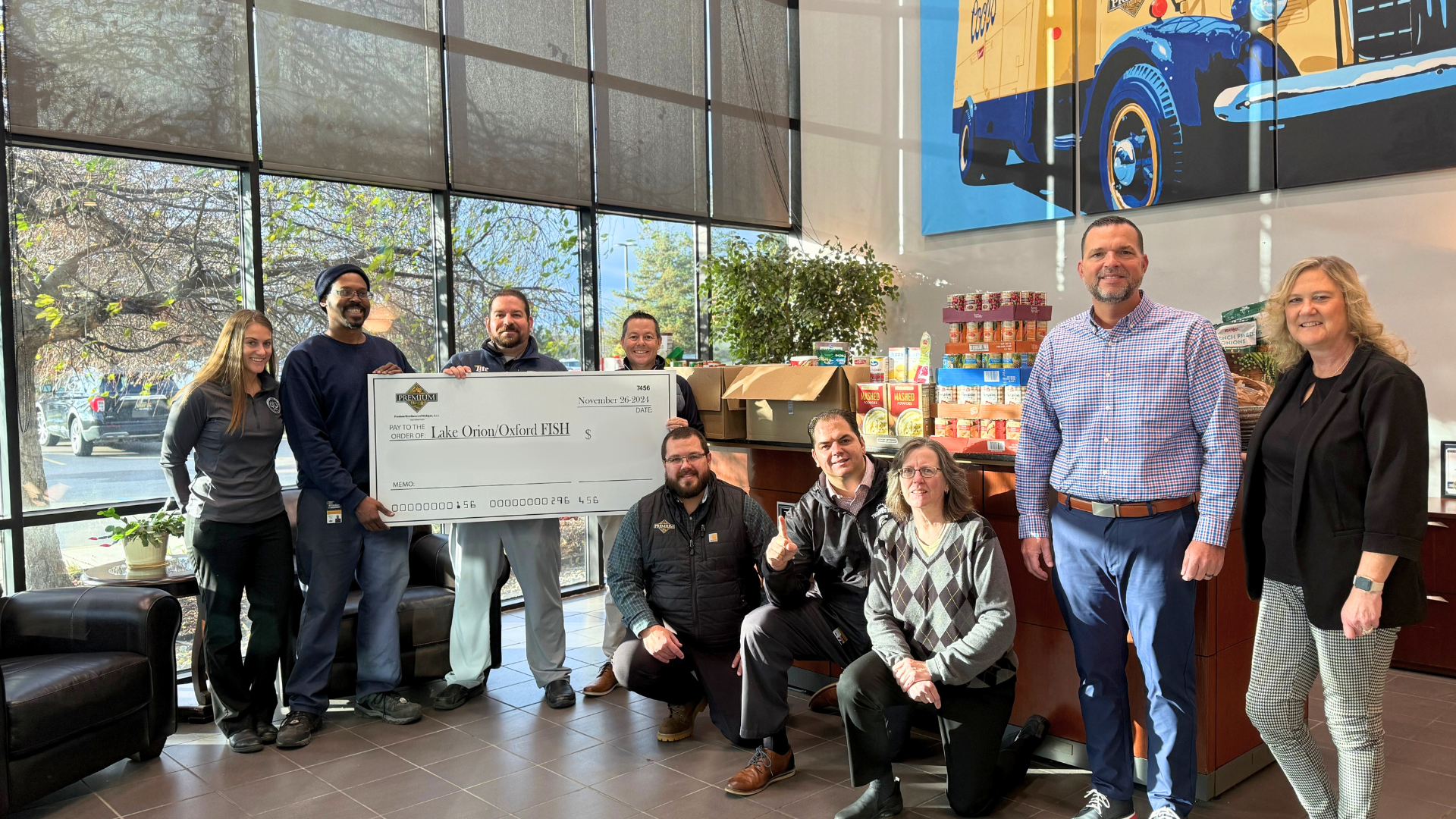 group of people holding check for charity donation