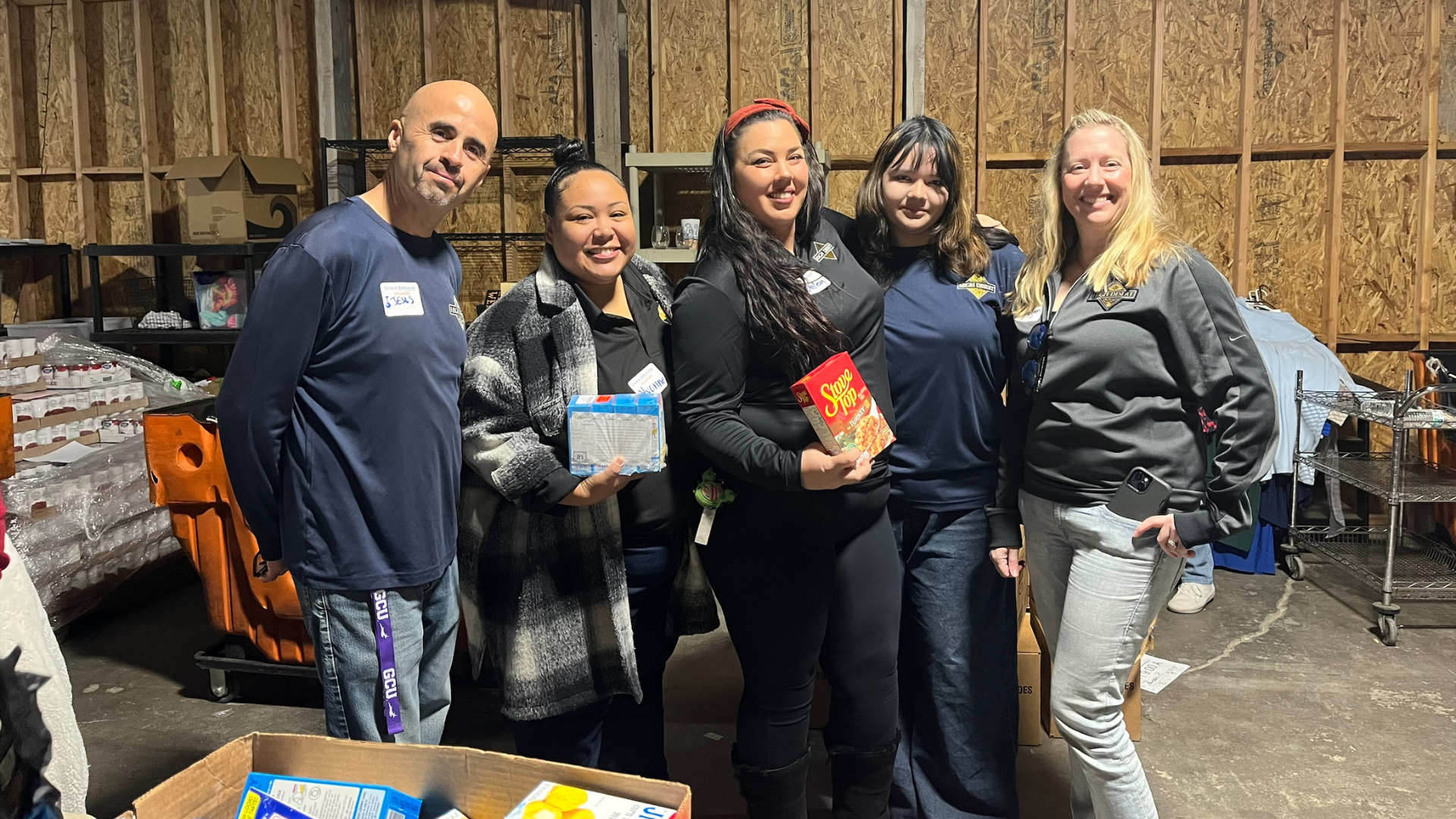 group of people holding food donations for the holidays