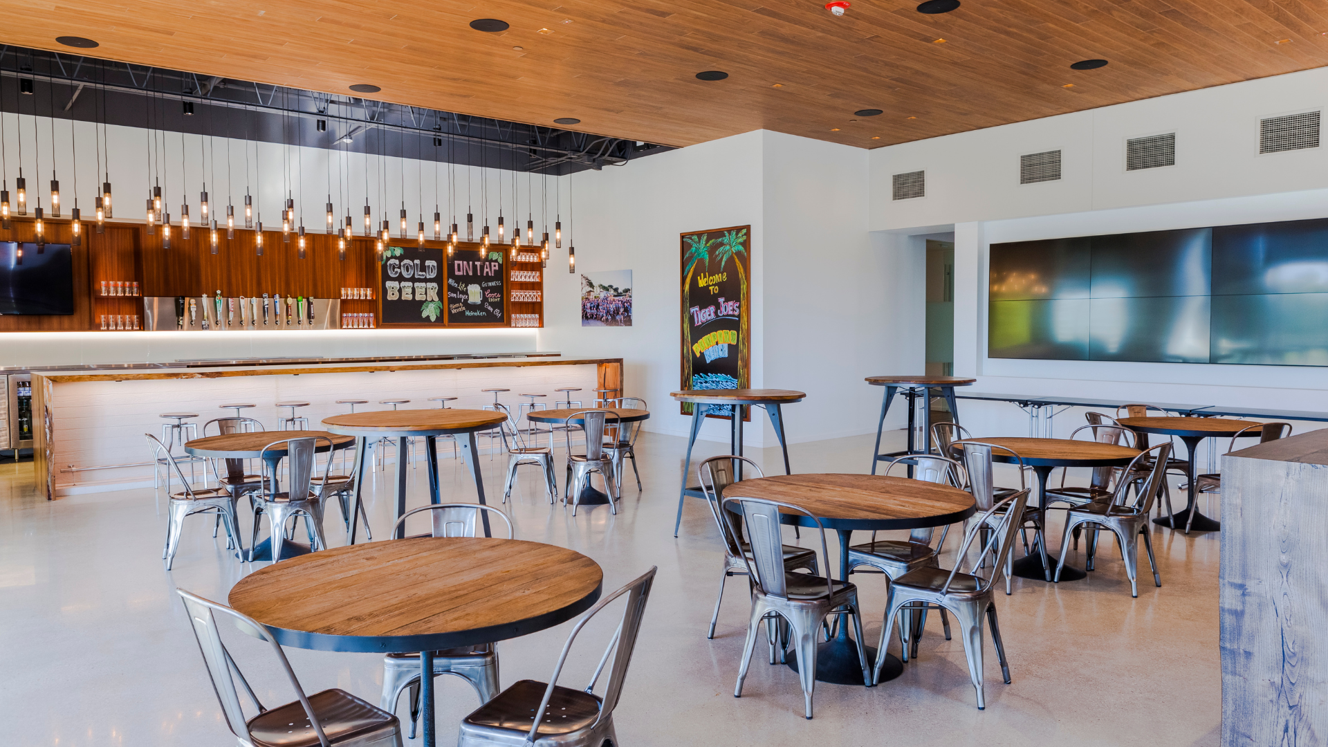 brightly lit company bar behind empty tables and chairs