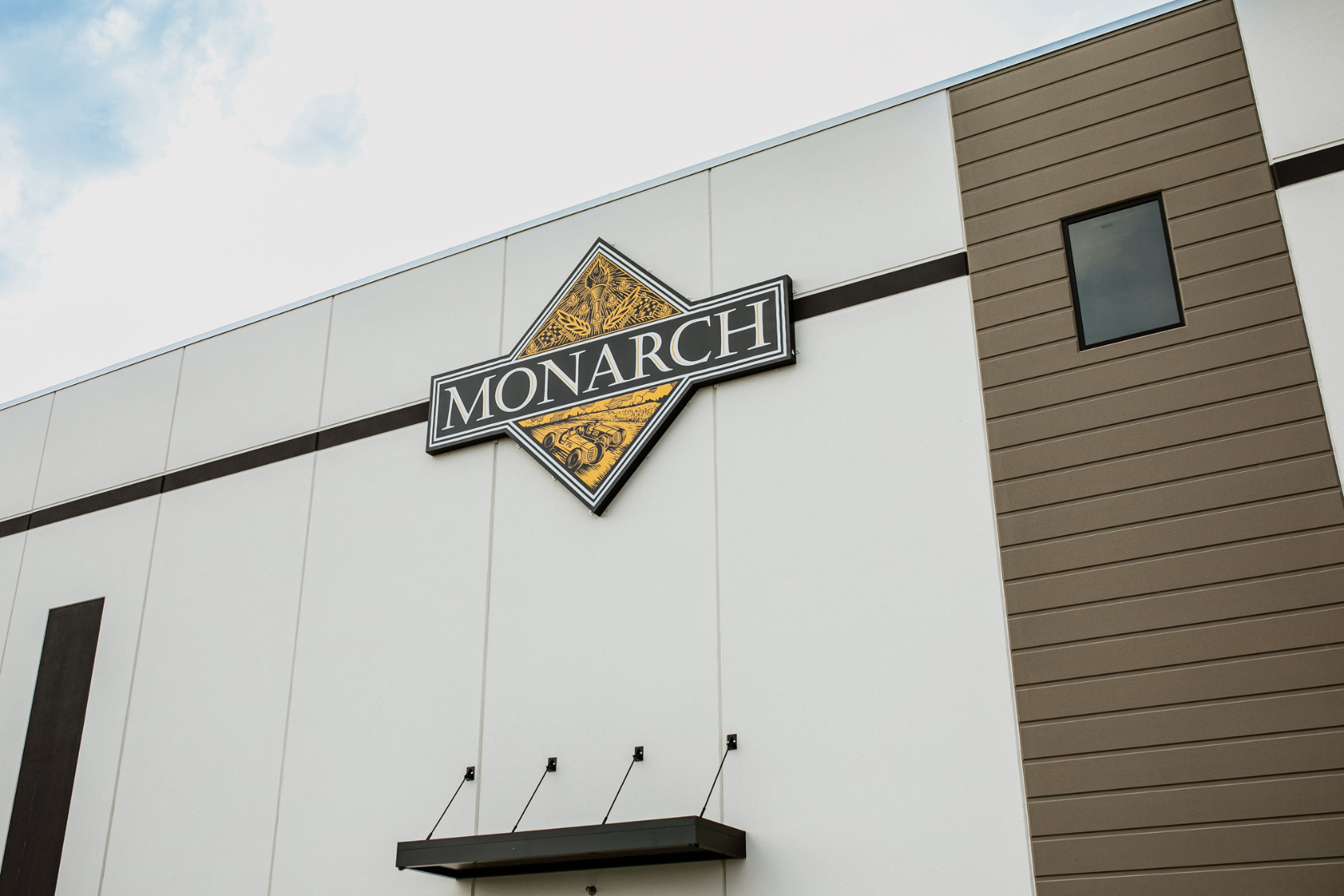 exterior warehouse facility with logo on wall