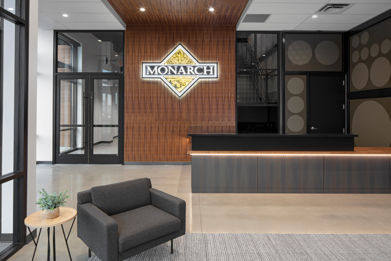 building reception with chair, desk and logo on wall