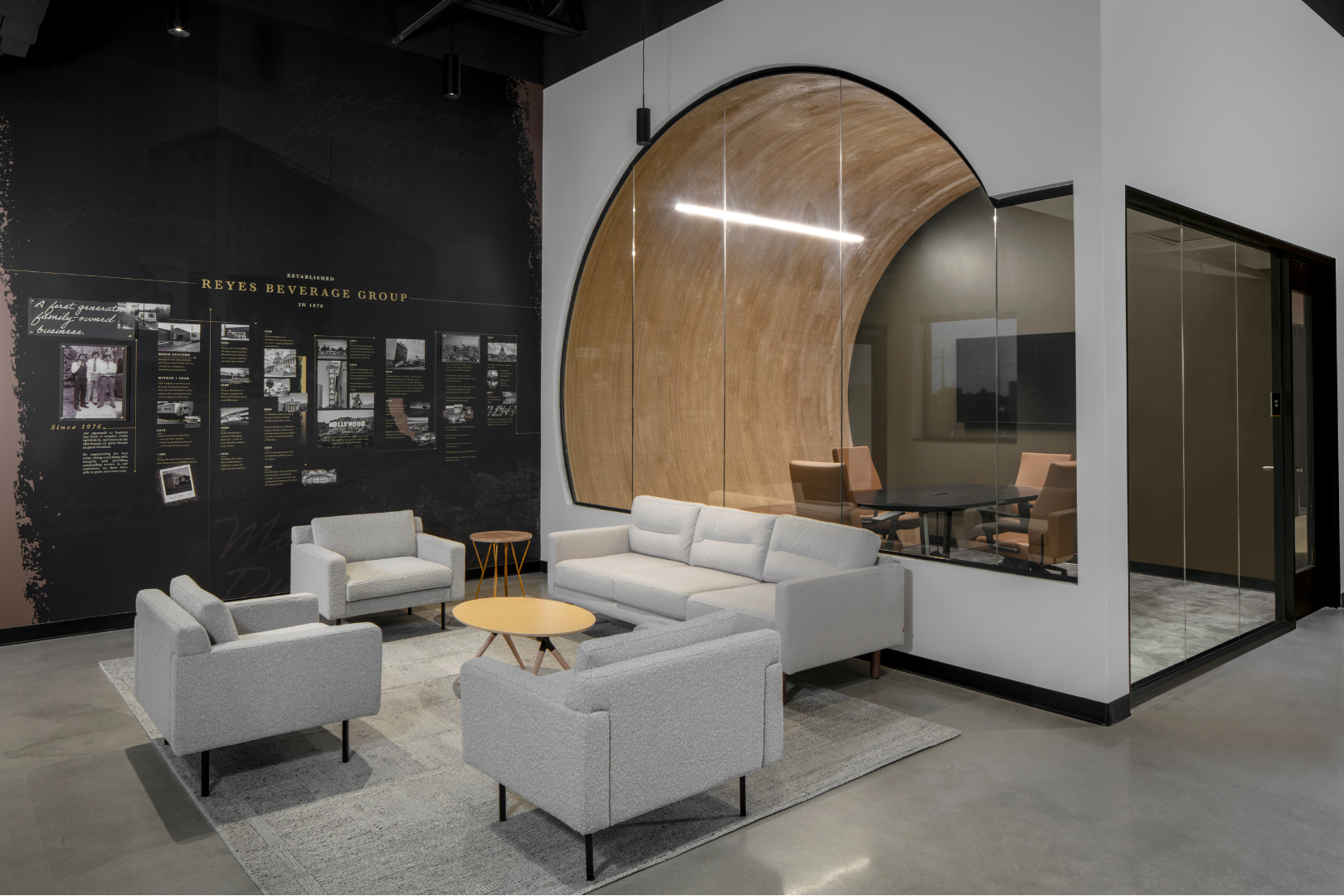interior building reception area with seating, a wall mural and a conference room