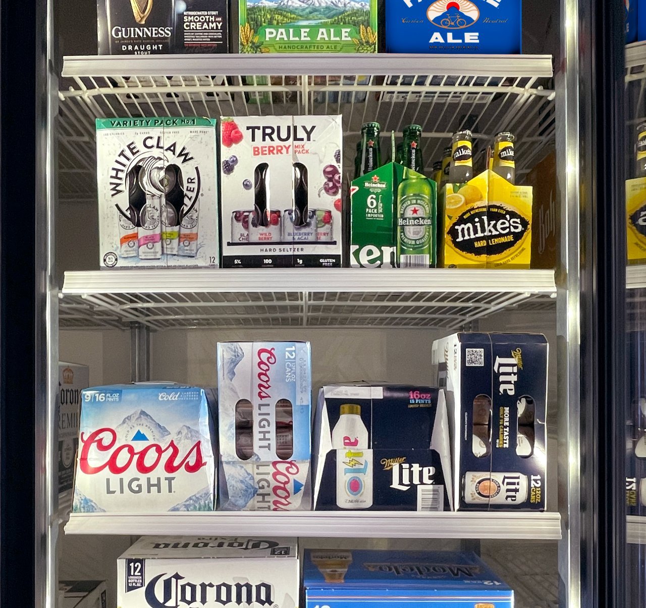 A retail cooler space filled with cases of beverages sold by Reyes Beverage Group
