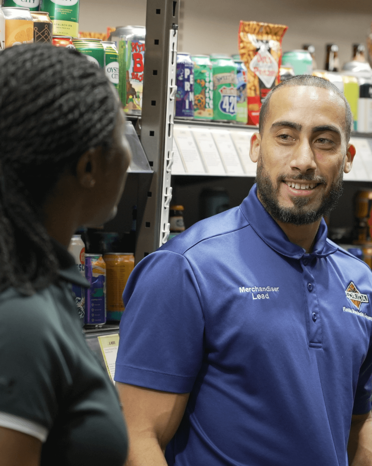 Photo of an employee smiling at another employee