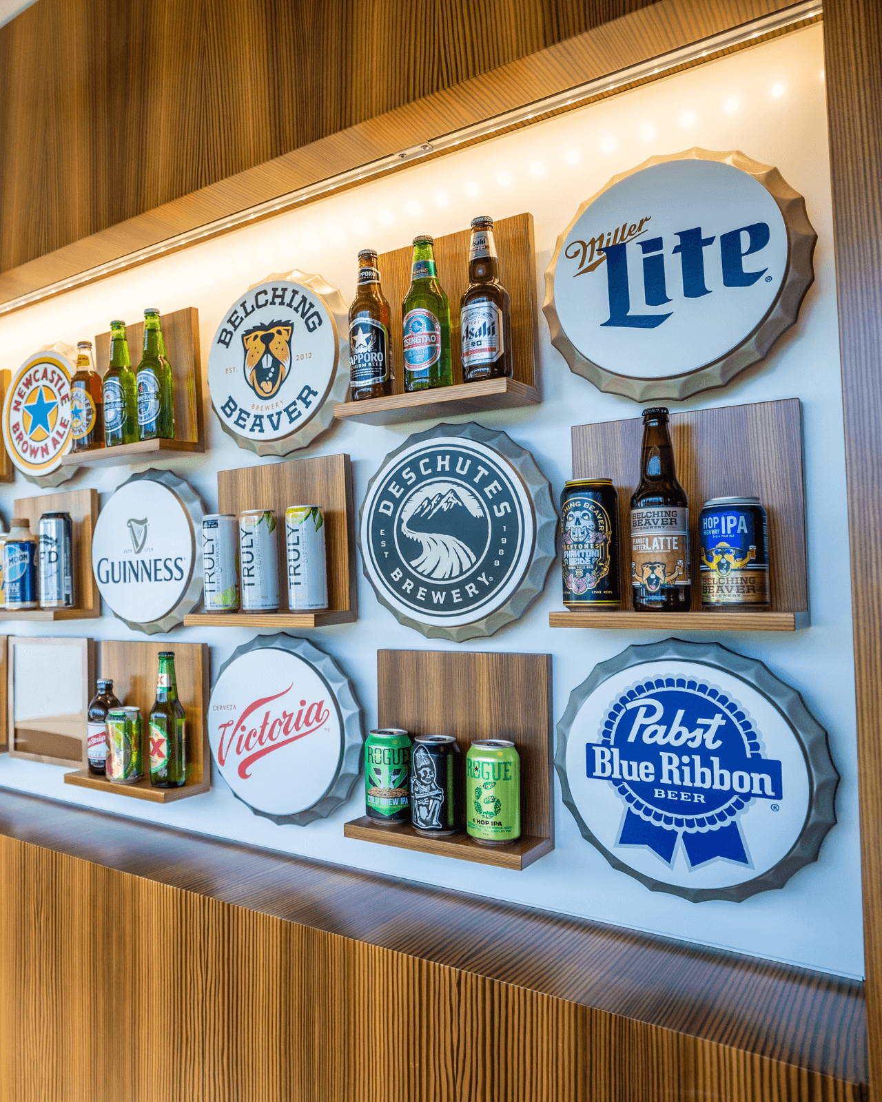 Photo of beer brand logos and products displayed on a wall