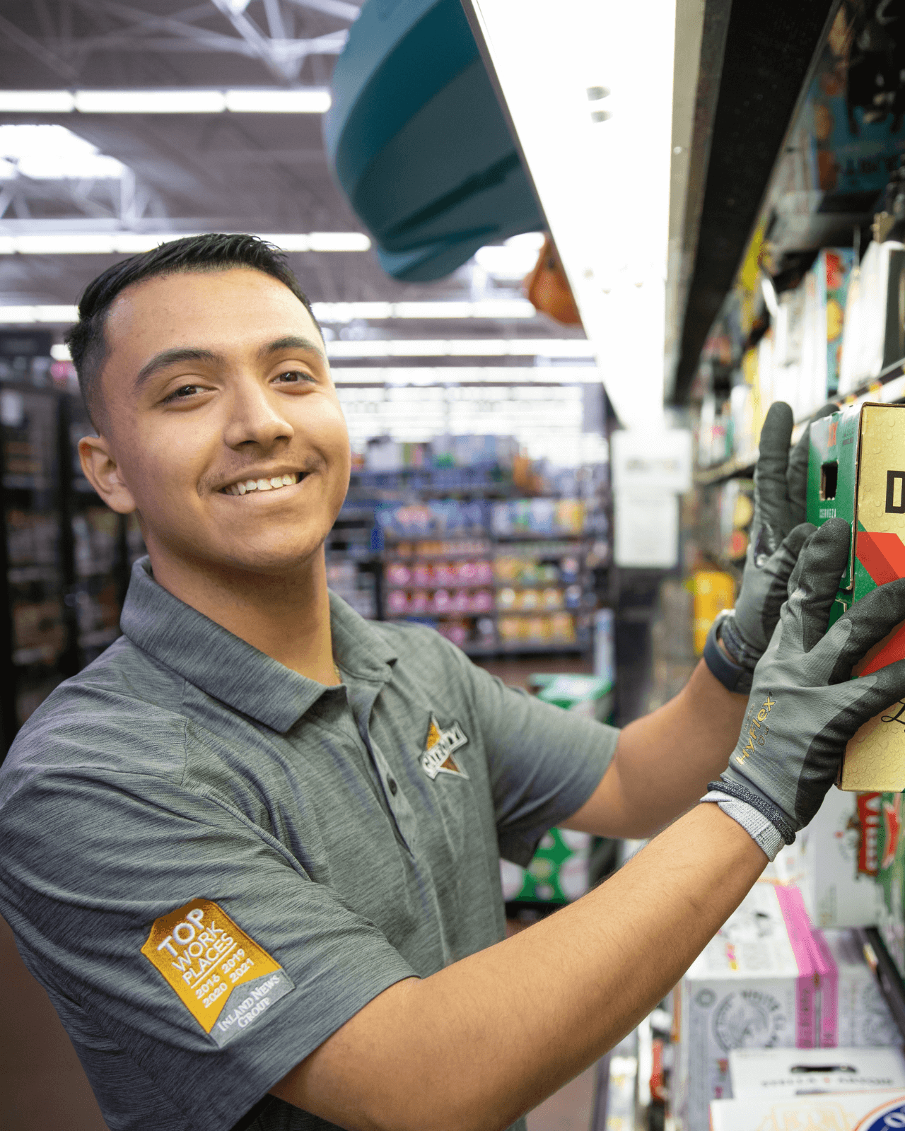 Photo of a merchandiser smiling while stocking product